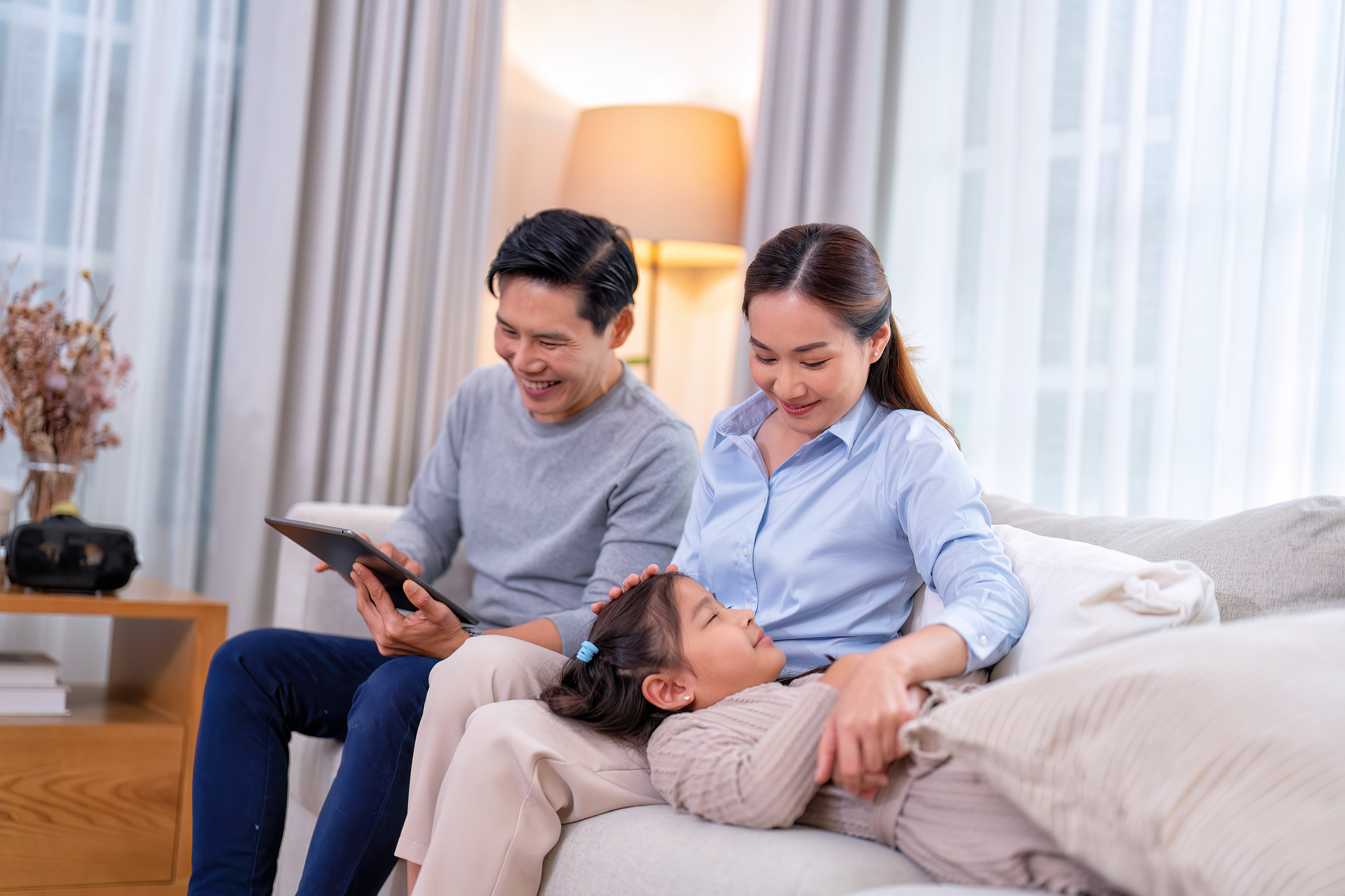 Happy family relaxing at home with comfortable heating and cooling